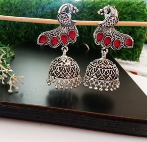 E0499_ Classy German silver oxidized crafted jumkas with peacock design and with a touch of bright red stones (medium size hanging)