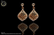 E040_Classy golden colored crafted earring with delicate work of white stone