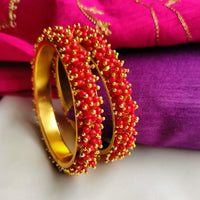 B0274_Lovely golden pearl bangles with delicate craftwork embellished with a bunch of red beads.