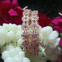 B0155_S_Elegant Rose gold bangle with flower design studded with American Diamond stones.