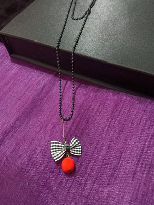 N0279_Trendy bead necklace with bow tie fabric pendant with a touch of beads.