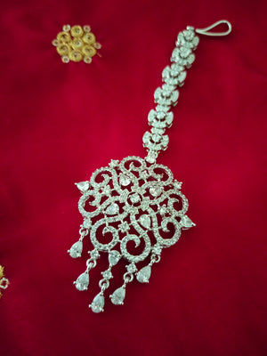 M027_Classic designer rhodium plated American diamond studded Maang tika with delicate stone work.