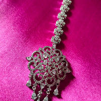 M027_Classic designer rhodium plated American diamond studded Maang tika with delicate stone work.