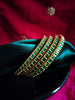 B0256_Gorgeous golden bangles embellished with a touch of green ruby stones.