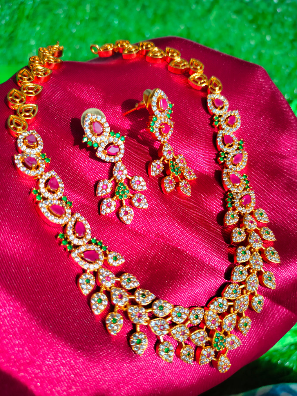 N0563_Classic matte gold polished temple jewelry style crafted design gold plated necklace set embellished with ruby and green stones .