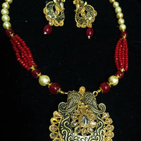 Pleasing and graceful Jaipur necklace laden with exquisite work of red & off white pearls and red crystal