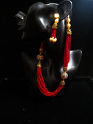 Pleasing and graceful necklace laden with exquisite work of red crystals, beautiful pearls and kundan