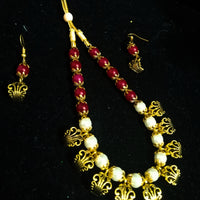 Pleasing and graceful Jaipur necklace laden with exquisite work of red & off white pearls .