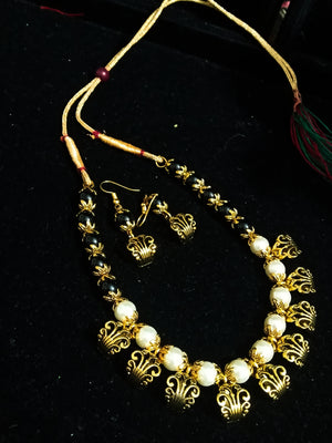 Pleasing and graceful Jaipur necklace laden with exquisite work of off white pearls .