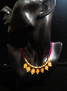 Pleasing and graceful gold plate-ted necklace laden with exquisite work of berry/wine purple colored crystals