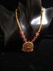 Pleasing and graceful gold plate-ted necklace laden with exquisite work of pink and green ruby