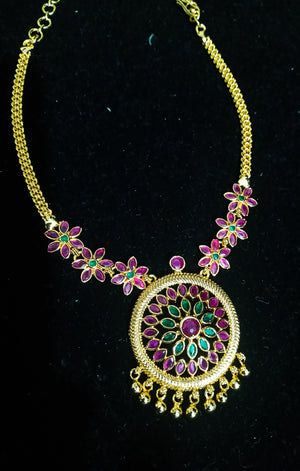 Pleasing and graceful gold plate-ted necklace laden with exquisite work of pink and green ruby