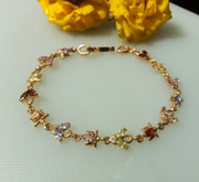 B044_Gorgeous Rose gold base bracelet studded with multi color semi precious stones.