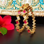 B019_Gorgeous Gold plated Bangles studded with white and pink ruby stones set of 2