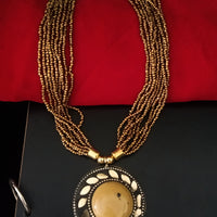 N0241_ Classic Off beat necklace with over sized circular pendant with a mustard color stone with beautiful craft work followed by layered bead chains.