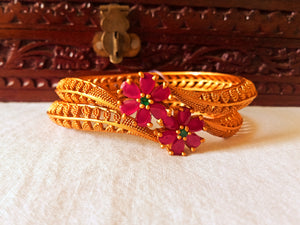 B037_Classy Gold plated bangles studded with pink ruby stones.