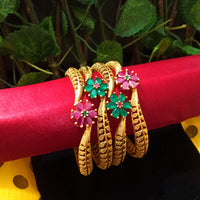 B0130_Exquisite bangles set with colorful metal bangles along with Matte gold plated bangles with a touch of stones with delicate flower design.