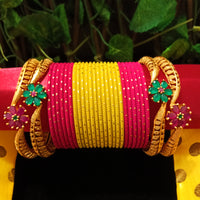 B0130_Exquisite bangles set with colorful metal bangles along with Matte gold plated bangles with a touch of stones with delicate flower design.