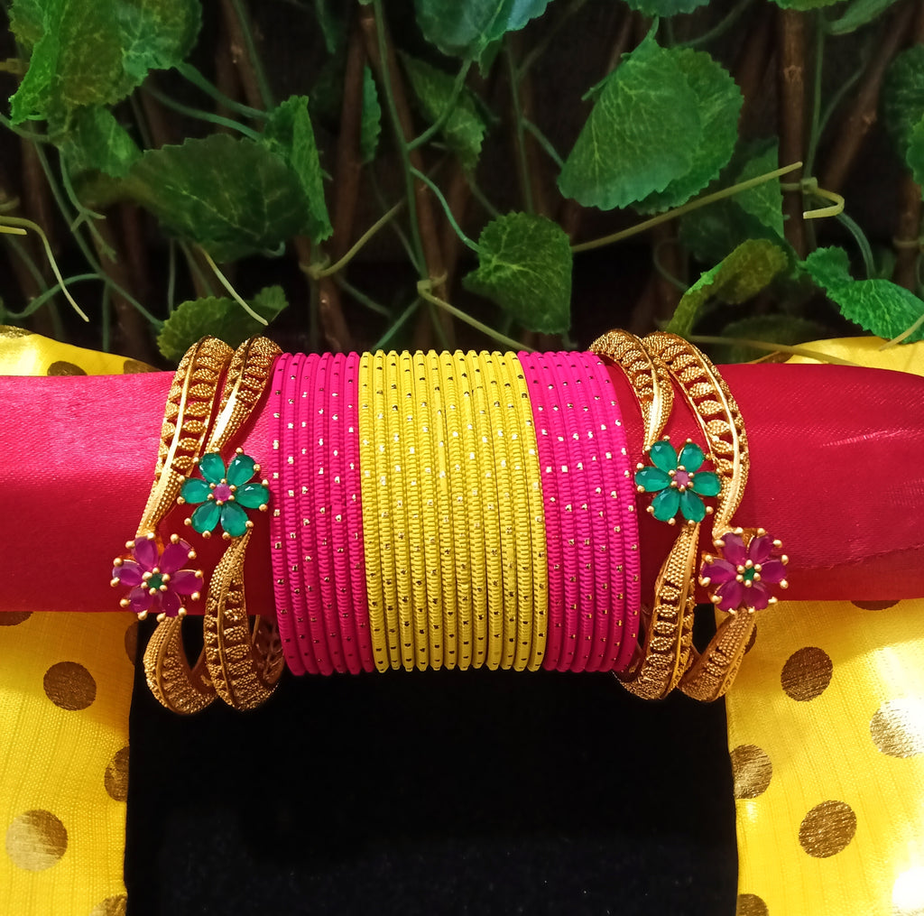 B0130_Exquisite bangles set with colorful metal bangles along with Matte gold plated bangles with a touch of stones with delicate flower design.