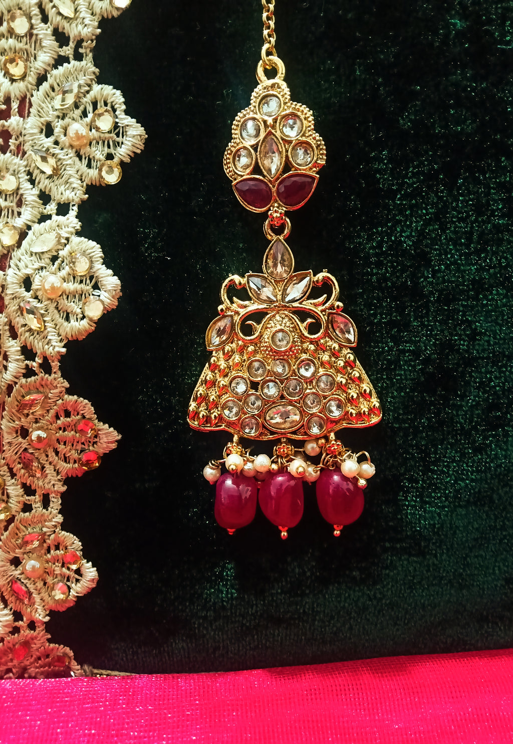 M06_Gorgeous stone studded Gold base color Maang Tika with delicate peacock design with touch of beads.