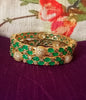 B0176_Gorgeous golden bangles embellished with American Diamond stones with a touch of green stones.