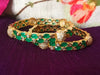 B0176_Gorgeous golden bangles embellished with American Diamond stones with a touch of green stones.