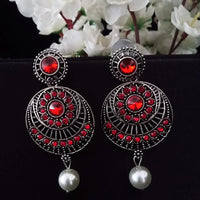 E0742_Classy german silver oxidized earrings with a touch of dazzling red stones with a pearl drop.