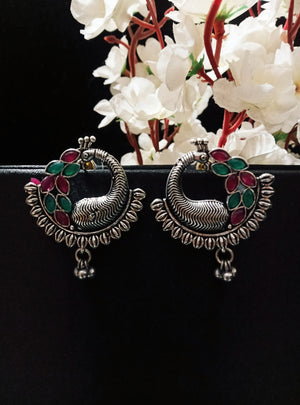 E0746_Trendy crafted german silver oxidized peacock design earrings with delicate work studded with pink and green stones with a touch of beads.