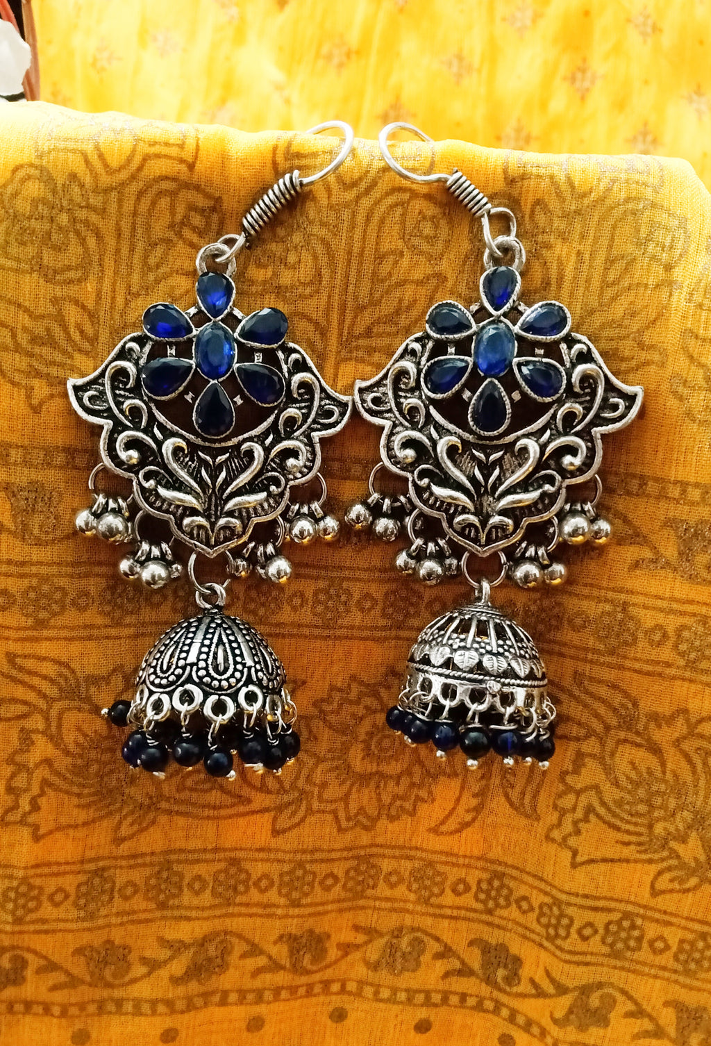 E0761_Classic crafted German silver oxidized danglers with a jumka drop along with a touch of stones and bead drops studded with blue stones.