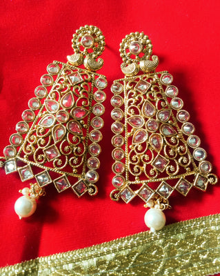 E0795_Grand crafted designer golden color danglers studded with a touch of dazzling american diamond stones with a touch of pearl drops.