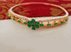 B0194_Lovely golden color bangle style bracelet studded with dazzling american diamond stones with a touch of glossy green  stones.