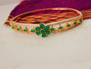 B0194_Lovely golden color bangle style bracelet studded with dazzling american diamond stones with a touch of glossy green  stones.