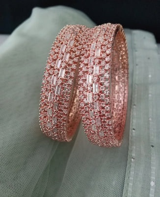 B0200_Grand broad design rose gold bangles studded with American Diamond stones with delicate stone work.