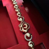 B0203_Elegant golden color bracelet studded with dazzling american diamond stones with delicate craft work.