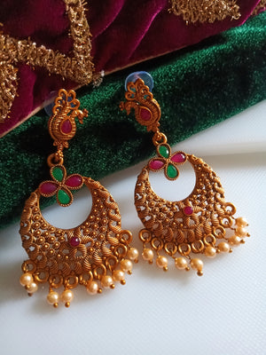 E0838_Beautiful golden color peacock design earrings studded with ruby stones with  bead drops.