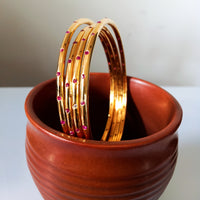 B0226_Beautiful sleek design  golden bangles with a touch of pink stones.