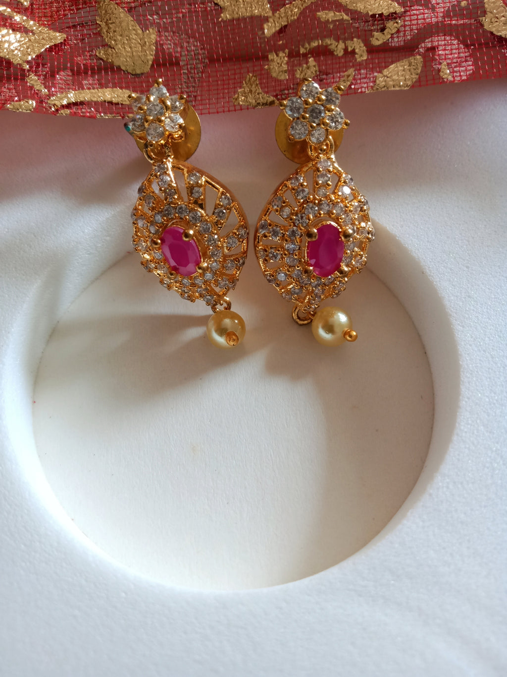 E0839_Gorgeous golden design earrings studded with american diamond stones with a touch of pink stones & pearl drops.