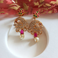 E0667_Beautiful crafted peacock design earrings studded with American diamond stones with a touch of pink & green stones with pearl drops.