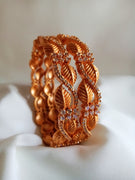 B0188_Gorgeous golden leafy design crafted bangles with delicate stone work embellished with American Diamond stones.