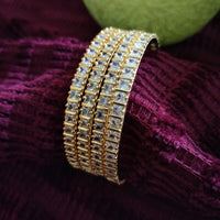 B0258_Gorgeous golden bangles embellished with a touch of American diamond stones.