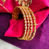 B0268_Classy sleek Gold plated bangles studded with  American Diamond  stones with delicate stone work.