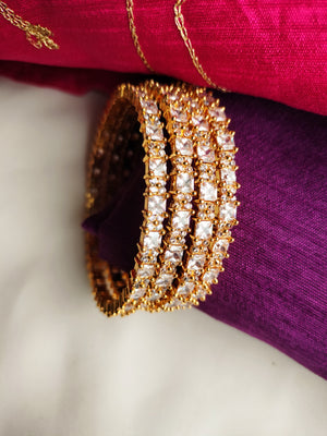 B0269_Classy sleek Gold plated bangles studded with  American Diamond  stones with delicate stone work.