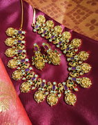 N0555_Traditional temple jewelry style Lakshmi design gold plated necklace set embellished with ruby stones .