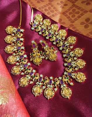 N0555_Traditional temple jewelry style Lakshmi design gold plated necklace set embellished with ruby stones .