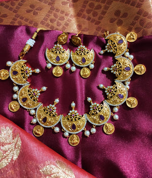 N0556_Classic temple jewelry style Lakshmi design gold plated necklace set embellished with ruby stones with a touch of pearls.