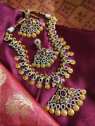 N0553_Grand temple jewelry style Lakshmi design gold plated necklace set embellished with ruby stones .