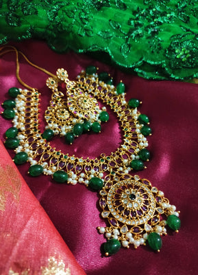 N0551_Grand designer gold plated necklace set embellished with ruby stones with green  bead drops.