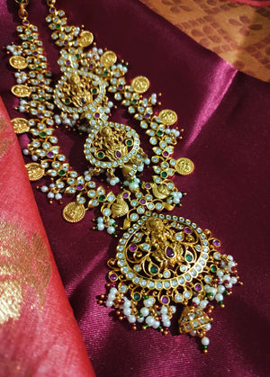 N0552_Grand designer lakshmi design gold plated necklace set embellished with ruby stones with a touch of bead drops.