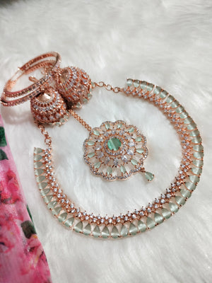 N0574_Elegant designer rose gold american diamond embellished necklace set with a touch of light green colour stones.