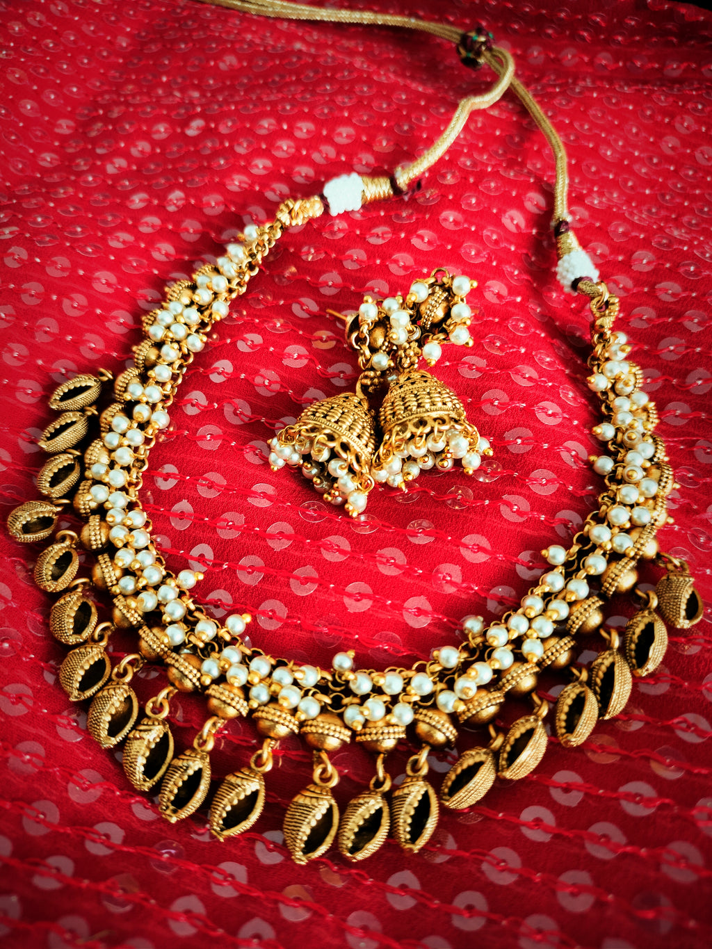 N03017_Shankha Design_Classic matte gold polished temple jewelry style  crafted design gold plated necklace set embellished with white stones .